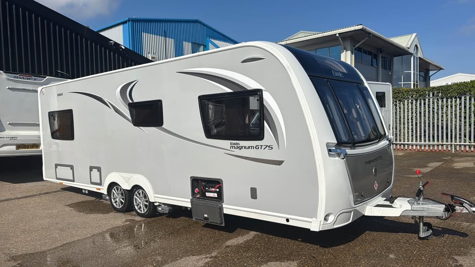 Touring caravan receiving mechanical repairs inside the workshop